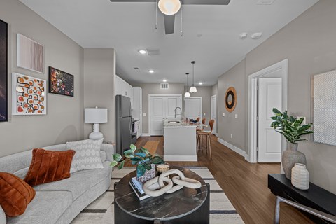 A modern living room with a grey couch and a coffee table in the center.