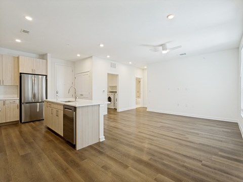 A kitchen with wooden floors and stainless steel appliances.
