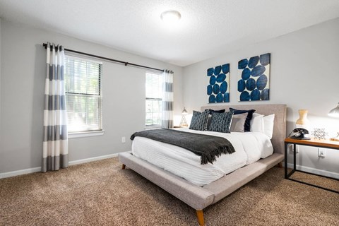 Bedroom with large windows and natural light in Jonesboro, GA apartments near Clayton State University