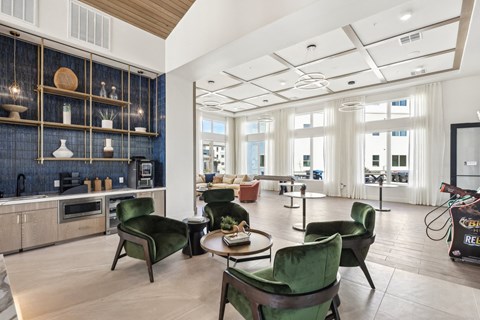 A modern kitchen with green chairs and a blue backsplash.