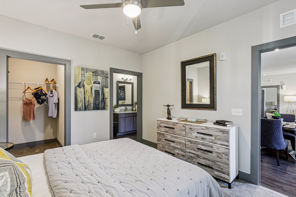 Comfortable bedroom with soft lighting, ceiling fan, and neutral tones at Lotus at Starkey Ranch in Odessa, Florida