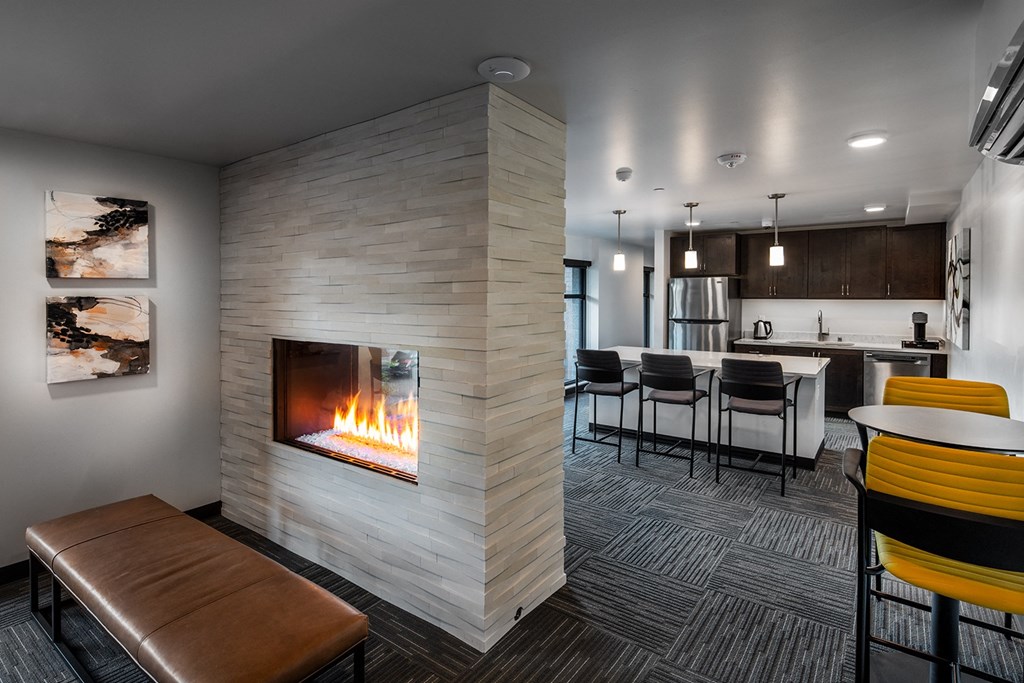 resident lounge with gas fireplace and kitchen