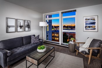 Apartments for Rent in Greenwood - The Morrow Living Room with Stylish Decor, White Walls, Vinyl Plank Flooring, and Large Windows - Photo Gallery 2