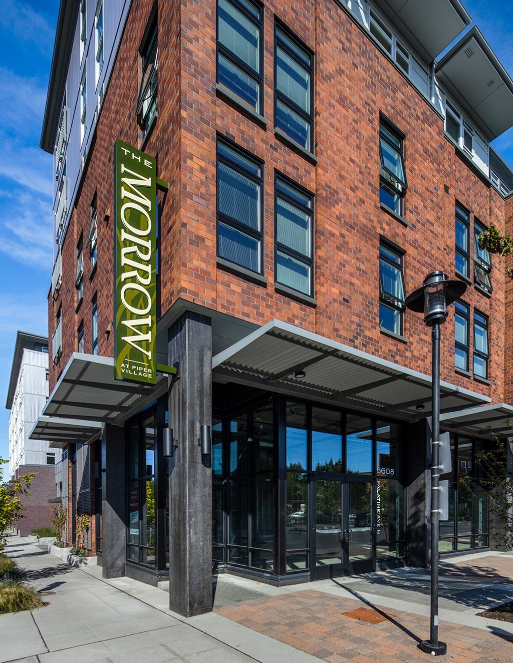 1 BR Apartments In Greenwood, WA - The Morrow - Exterior View Of Property With Brick Details and Many Windows