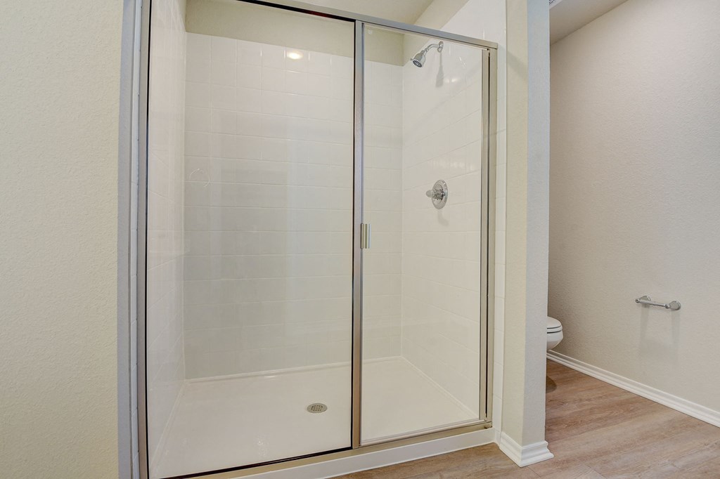 a shower with a glass door in a bathroom