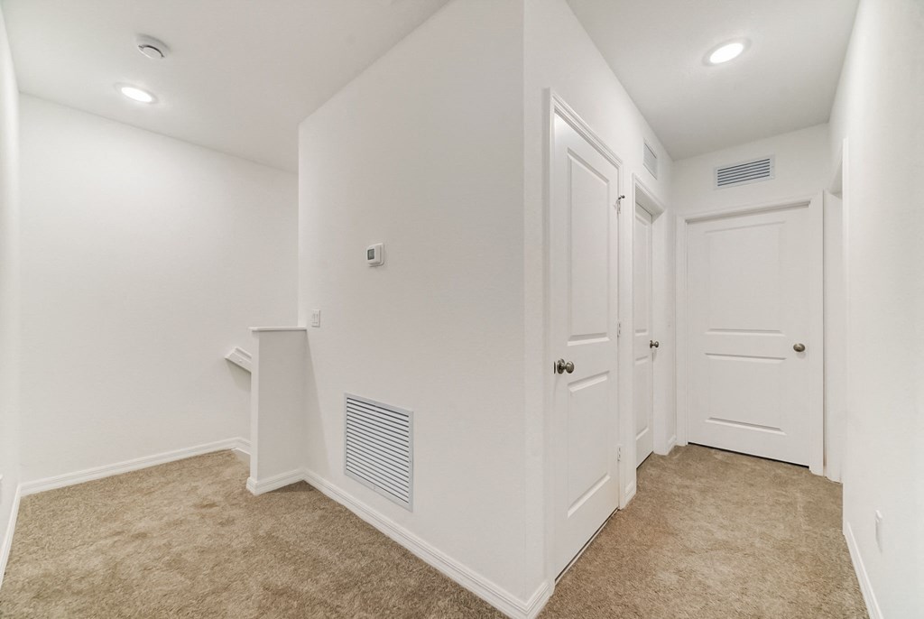 Boatman Hammock Townhomes in Lake Worth, FL photo of  a room with white walls and white doors and a carpeted floor