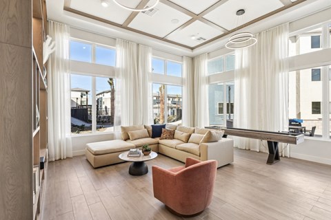 A living room with a large sectional sofa and a coffee table.