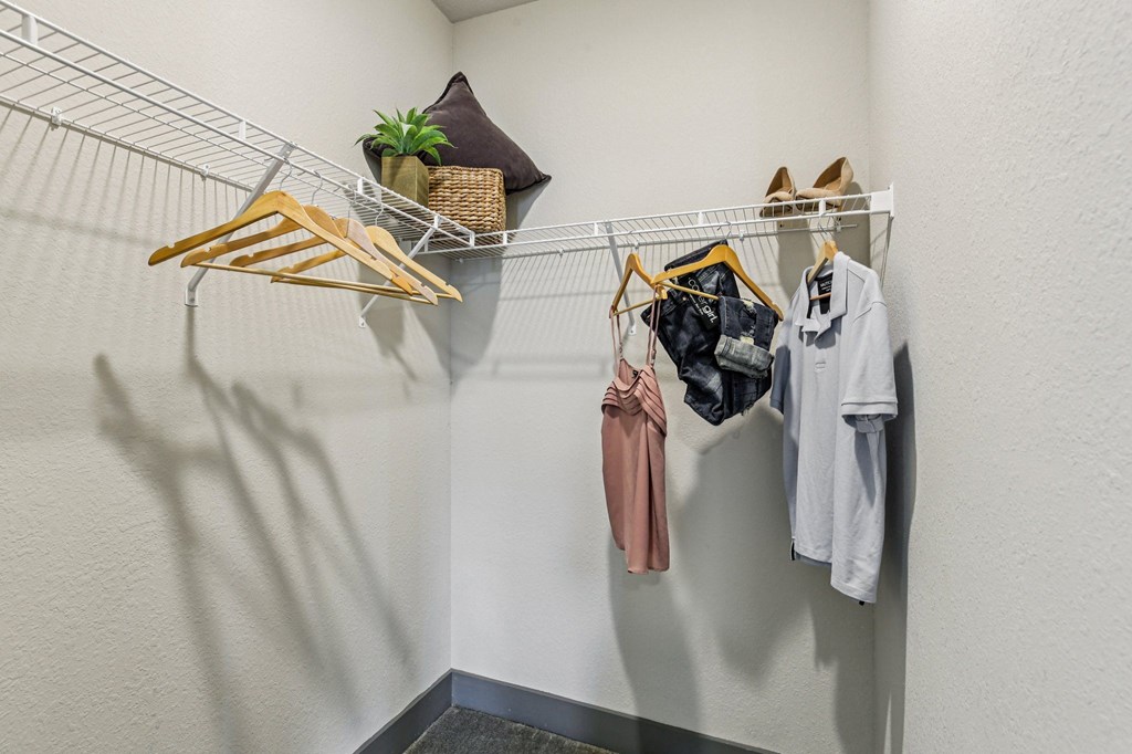 Large walk-in closet with built-in shelving at Lotus at Starkey Ranch in Odessa, Florida.