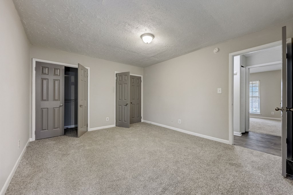 Apartments In Sandy Springs, GA for Rent – Celebration at Sandy Springs - an empty living room with two doors and a door to a hallway
