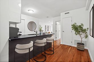 a kitchen with white walls and a black countertop