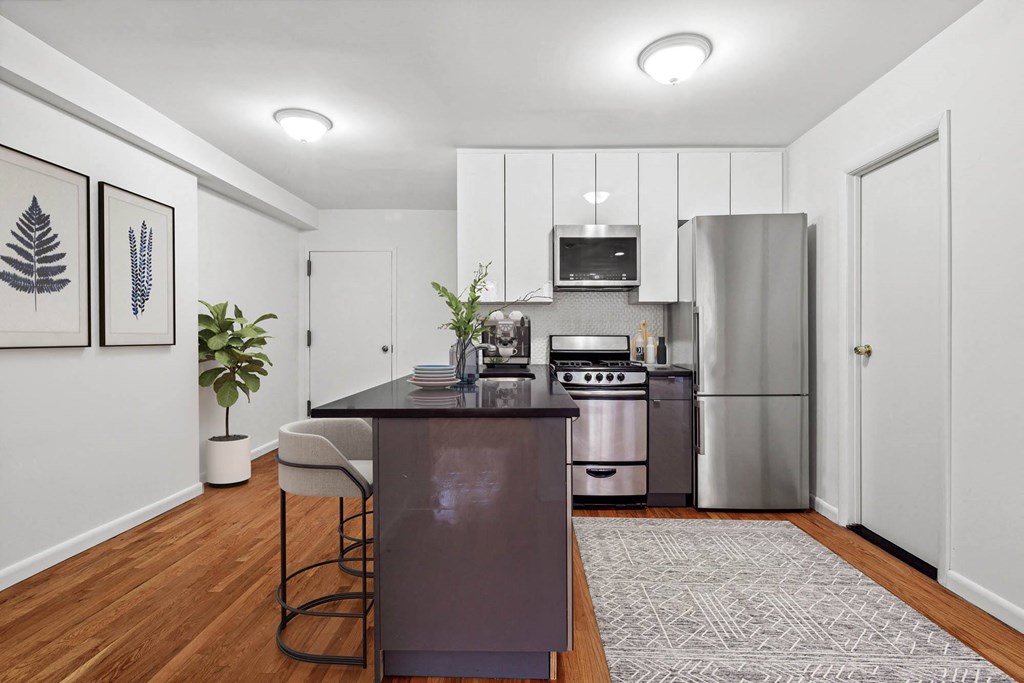 a kitchen with a large island and stainless steel appliances