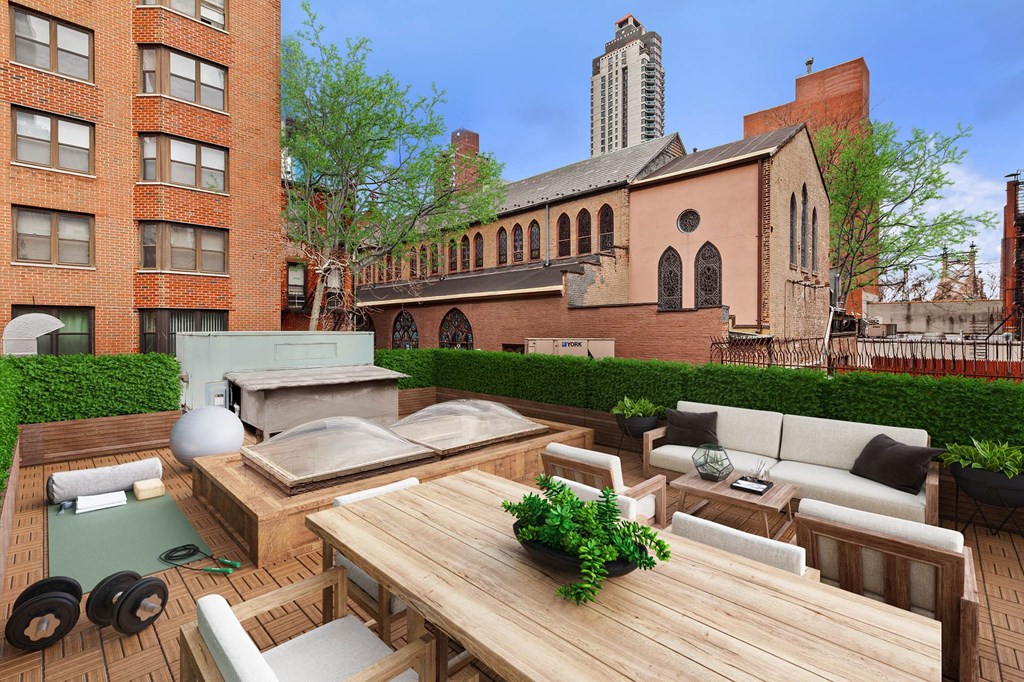 a terrace with a wooden table and chairs