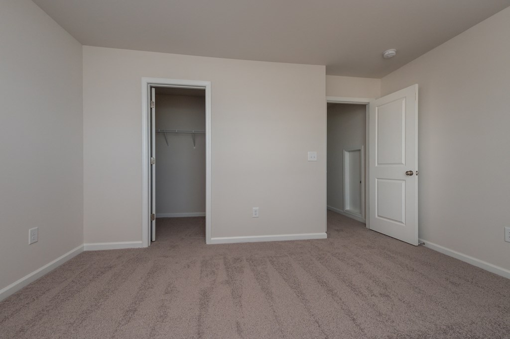 a bedroom with a closet and an open door