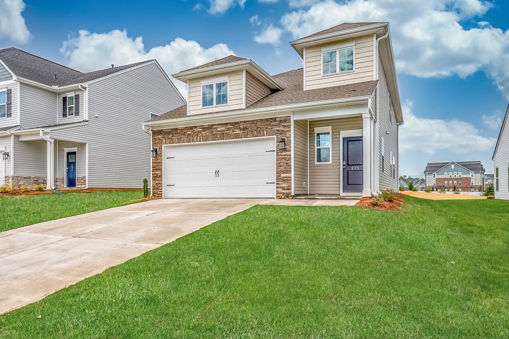 3 and 4 Bedroom Homes For Rent In Fountain Inn, SC - Pine Ridge Place - Front Yard Of House Surrounded By Lush Grass. Two Car Garage And Drive Way Attached To House