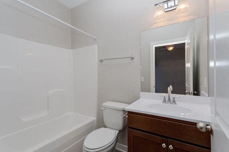 a bathroom with a sink toilet and a mirror