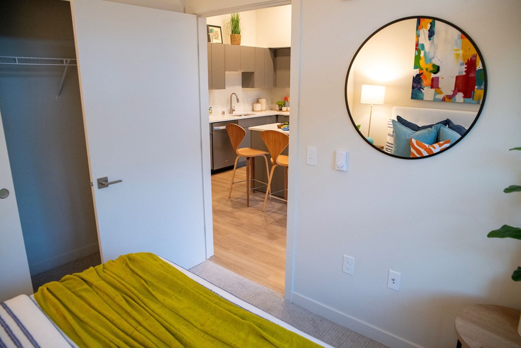 a bedroom with a yellow bed and a mirror on the wall