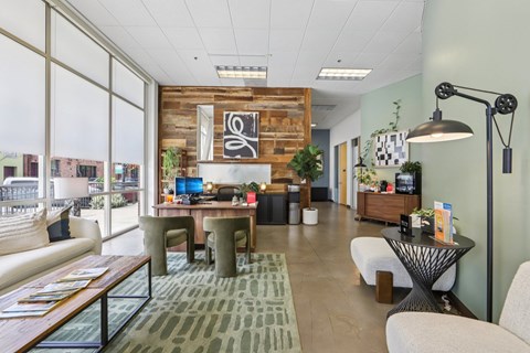 A modern office space with a wooden accent wall and a variety of seating options.