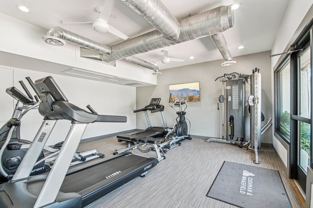 A well-equipped gym with treadmills, exercise bikes, and other equipment.