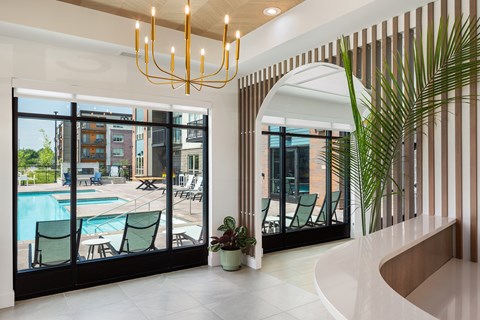 A modern interior with a pool and a view of the outside.