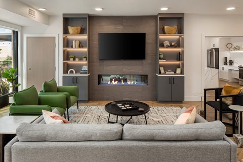 A modern living room with a grey sofa and a television.