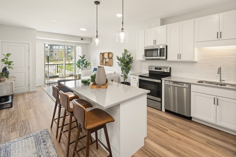 A modern kitchen with white cabinets and a central island.