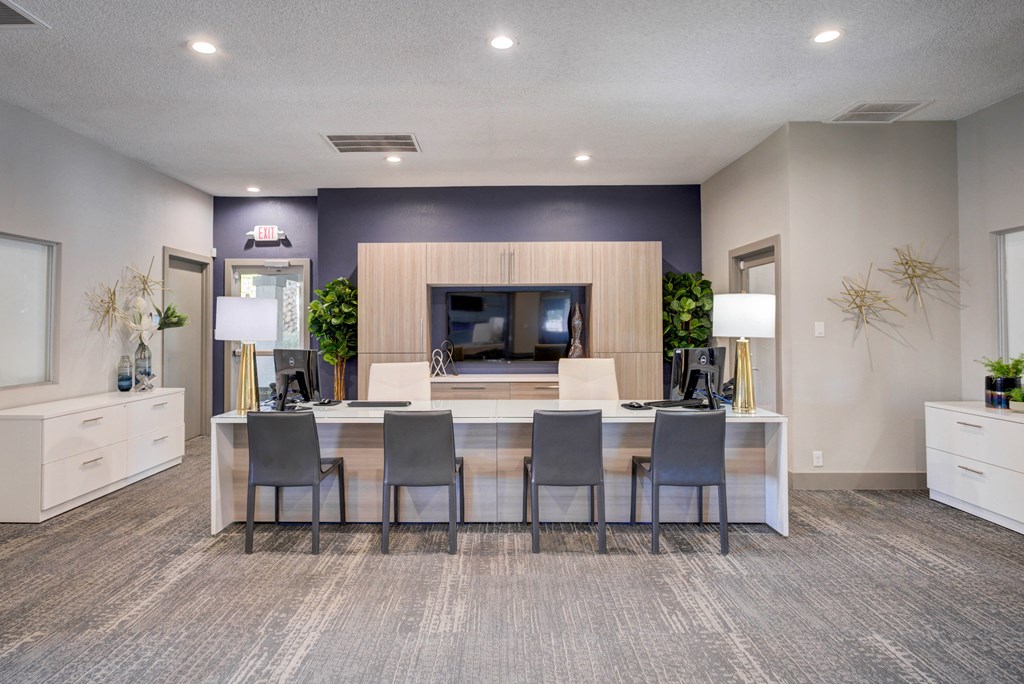 a dining room with a table and chairs in front of a tv