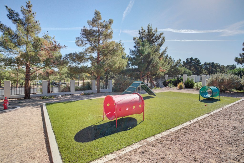 a playground with a seesaw and other playground equipment in a park