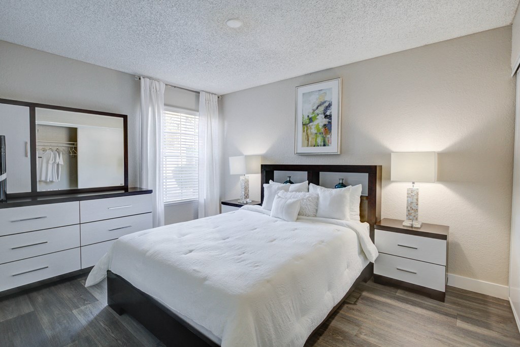 the preserve at ballantyne commons apartment bedroom with white bed and dressers