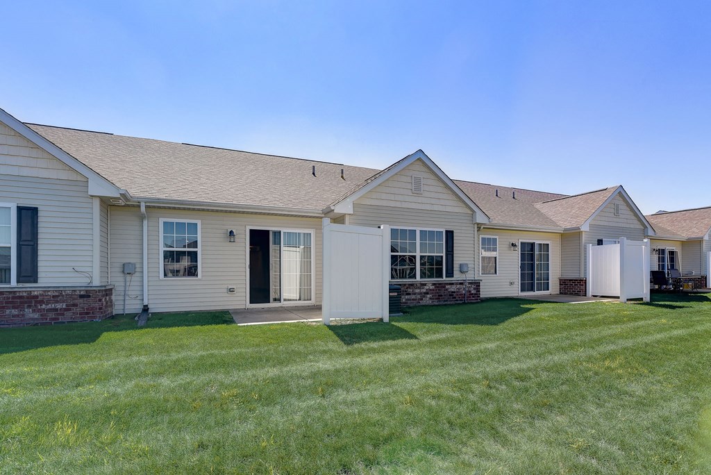 a white house with a yard and grass