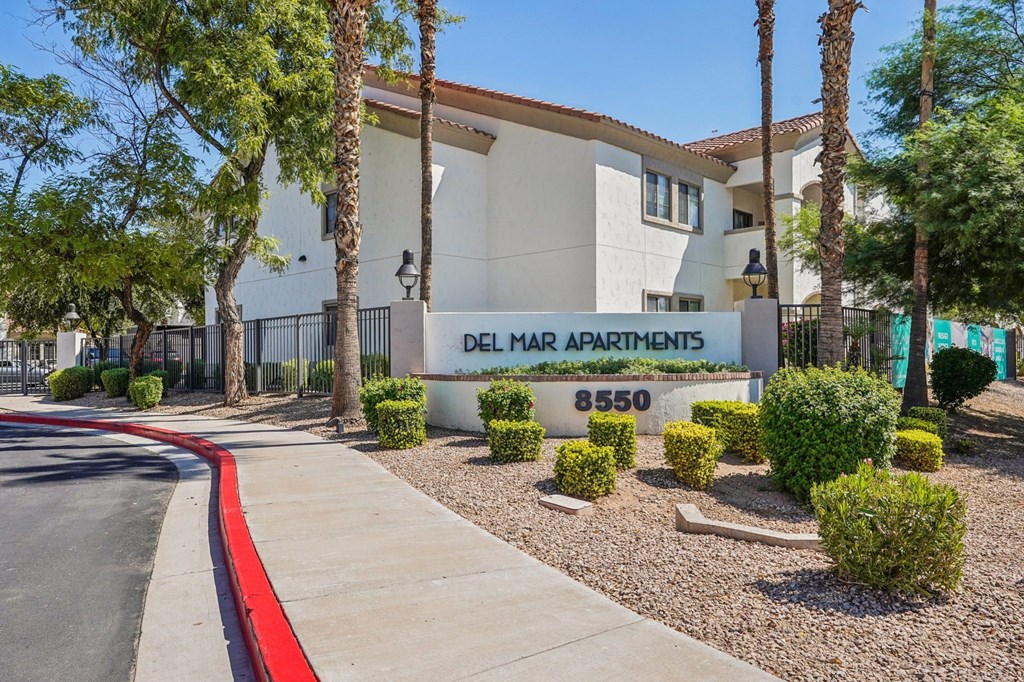 A building with a sign that says Delmar Apartments.