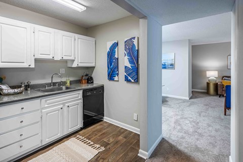 a kitchen with white cabinets and a counter top