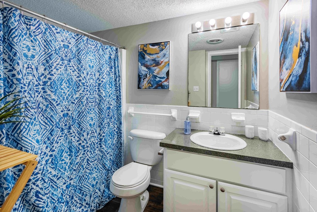 Grand Arbor Reserve Apartments in Raleigh, NC photo of a bathroom with a blue and white shower curtain