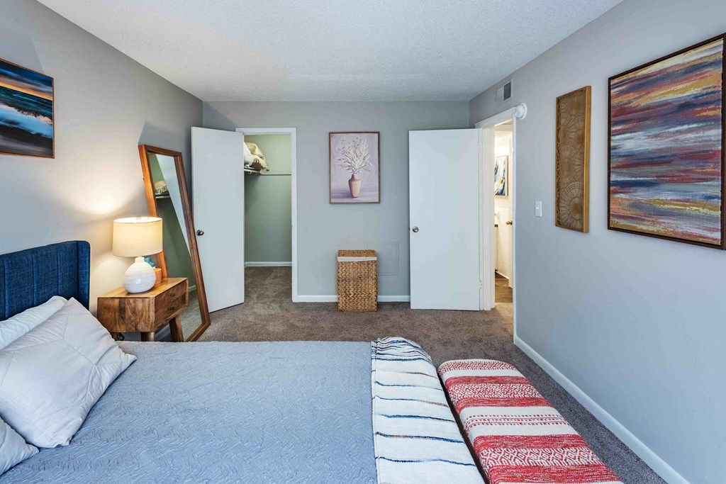 Grand Arbor Reserve Apartments in Raleigh, NC photo of a bedroom with a bed and a mirror