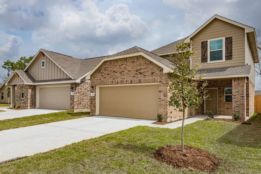 Homes for Rent in Humble TX - Edgewater at the Lagoon - Large House with a Brick Facade, Attatched Garage, and Driveway