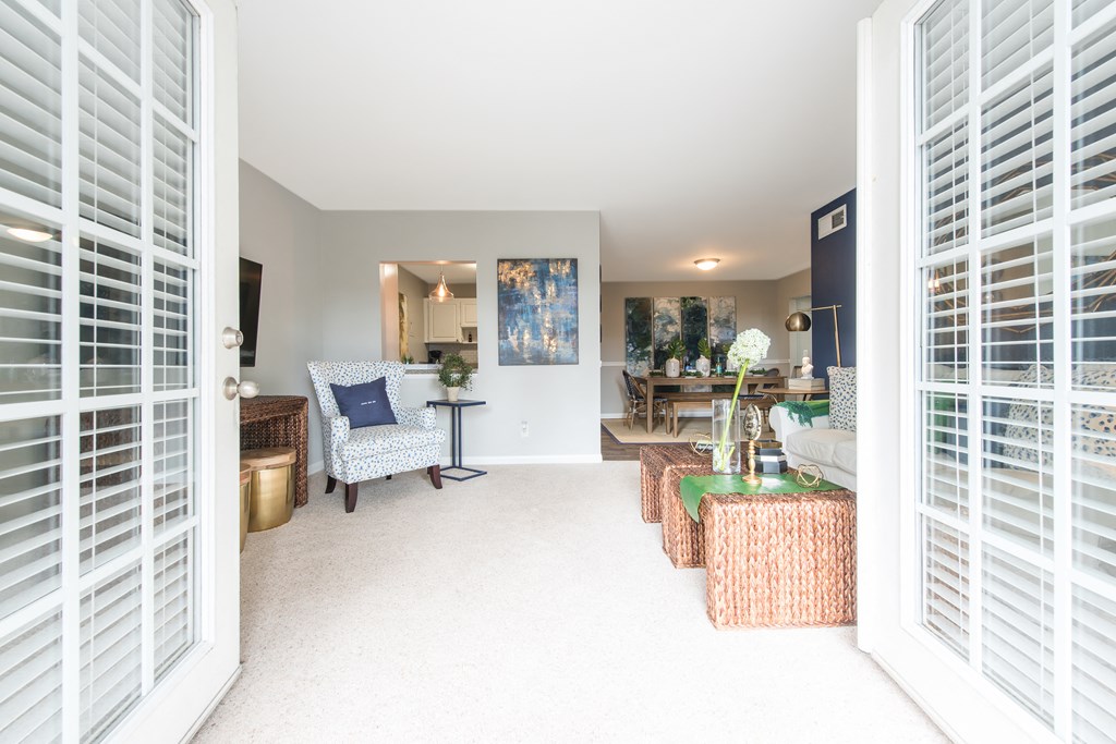 Apartments In Sandy Springs, GA for Rent – Celebration at Sandy Springs - a living room with french doors leading into a dining room