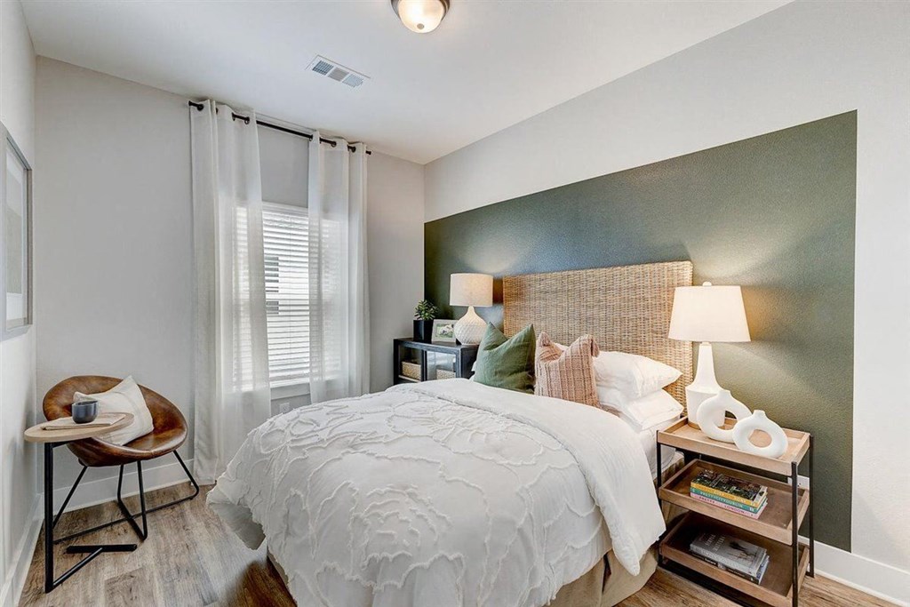 a bedroom with a large bed and a window