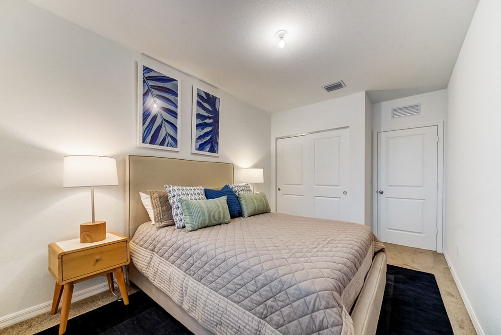 Boatman Hammock Townhomes in Lake Worth, FL photo of  a bedroom with a large bed and two windows