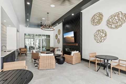 A modern dining room with a black table and chairs.