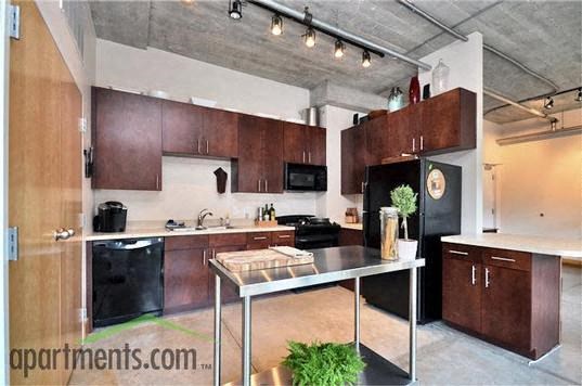 a kitchen with a table and black appliances
