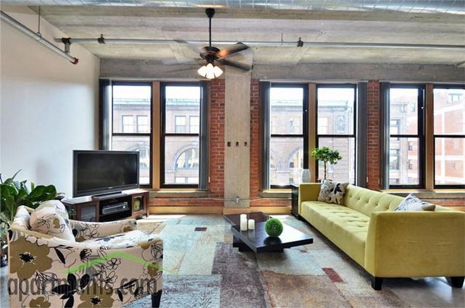 a living room filled with furniture and a flat screen tv