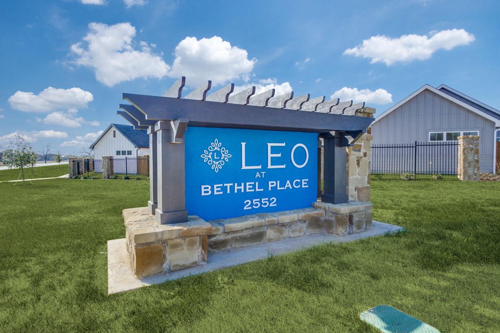 A sign that says Leo at Bethel Place 2552 in front of a building.