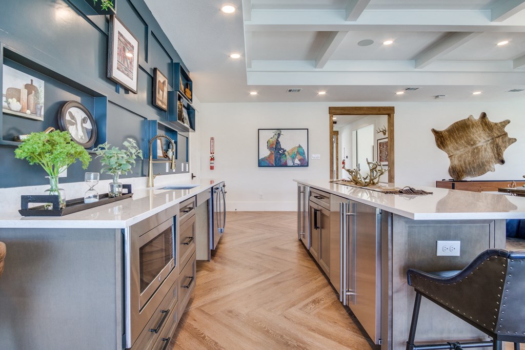 A kitchen with a white counter top and stainless steel appliances.