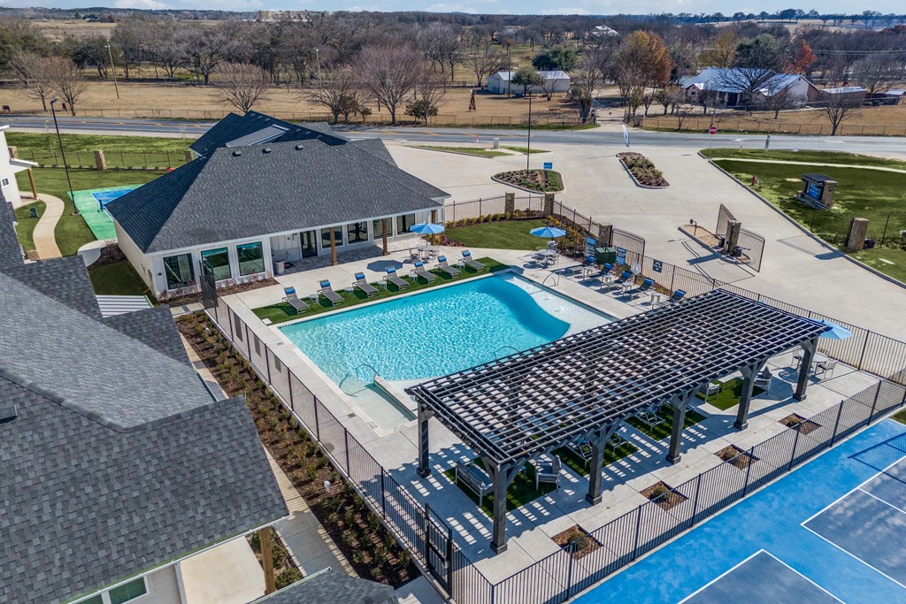 A pool with a pavilion and a fence around it.