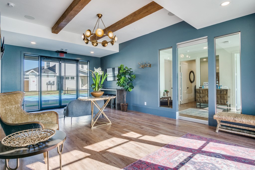 A living room with a wooden floor and a large window.