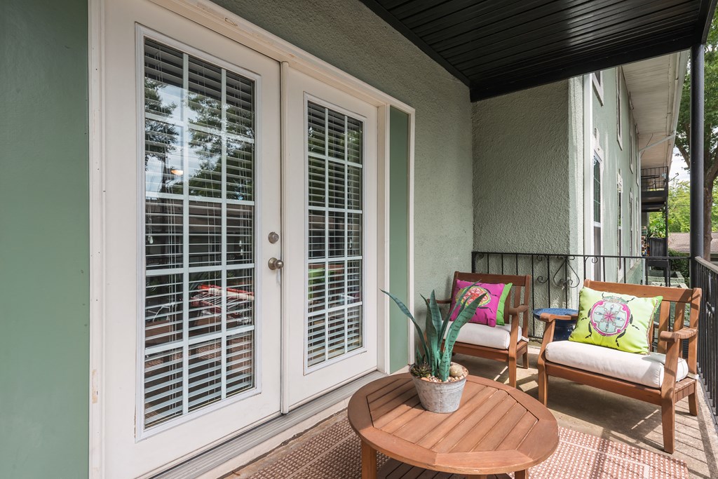 Pet-Friendly Apartments in Sandy Springs – Celebration at Sandy Springs - a patio with two chairs and a table