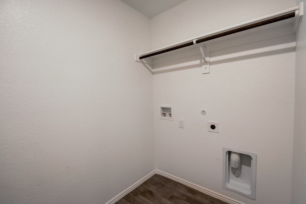 an empty room with a urinal on the wall and a window