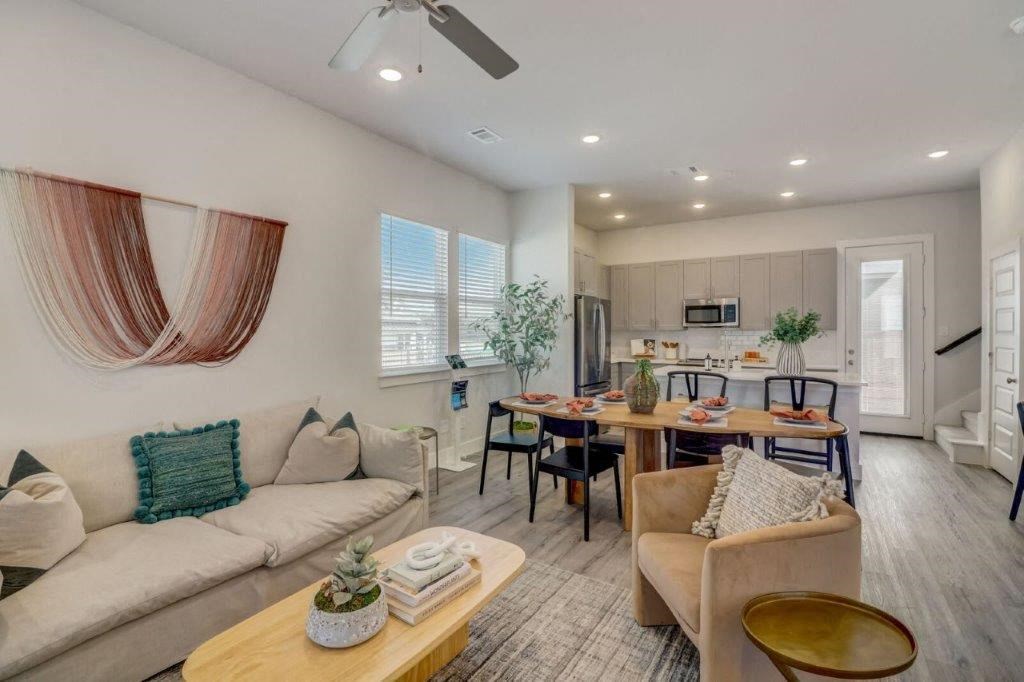 a living room and kitchen with a couch and a table