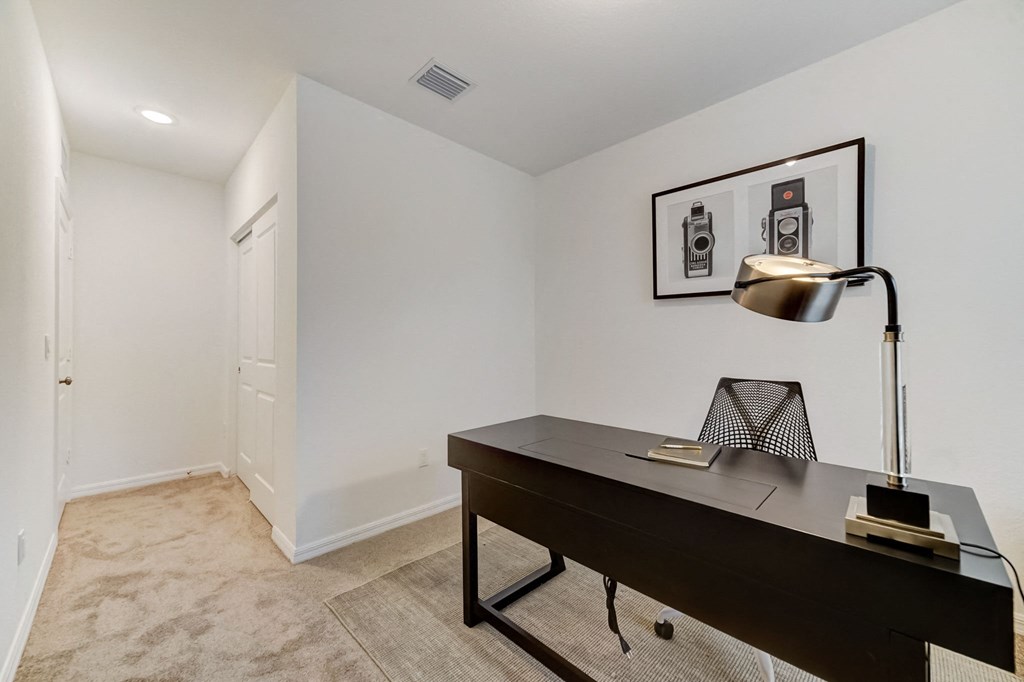 Boatman Hammock Townhomes in Lake Worth, FL photo of  a home office with a desk and a lamp and a white door
