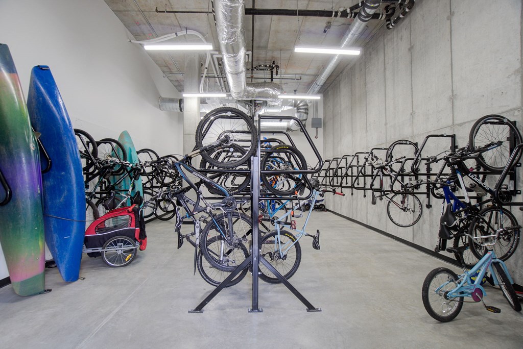 a large room filled with bikes and surfboards in a building