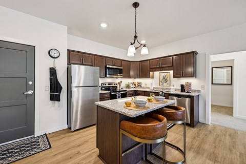 A modern kitchen with a wooden table and chairs.